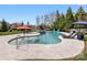 Backyard pool and hot tub surrounded by stone pavers, lounge chairs, and well-maintained landscaping at 5501 Two Iron Dr, Matthews, NC 28104