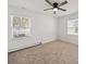 Well-lit bedroom featuring neutral carpet, two windows, and a ceiling fan at 5600 Burleson Dr, Charlotte, NC 28215