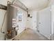 Utility room featuring a hot water heater and a door to the exterior at 5600 Burleson Dr, Charlotte, NC 28215