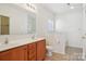 Bright bathroom featuring a double vanity, neutral walls, and tile flooring at 616 Smokehouse Ln, Albemarle, NC 28001