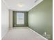 Well-lit bedroom featuring carpet, soft green walls, and a window with blinds at 616 Smokehouse Ln, Albemarle, NC 28001