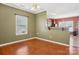 Open dining area with hardwood floors, a window, and view to a kitchen with bar seating at 616 Smokehouse Ln, Albemarle, NC 28001