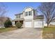 Two-story home with a two-car garage, stone accents, and a well-maintained lawn, perfect for suburban living at 616 Smokehouse Ln, Albemarle, NC 28001