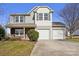 Two-story home with a two-car garage, stone accents, and a well-maintained lawn, perfect for suburban living at 616 Smokehouse Ln, Albemarle, NC 28001