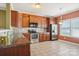 Kitchen featuring tile flooring, stainless steel appliances, and granite countertops with eat-in dining area at 616 Smokehouse Ln, Albemarle, NC 28001