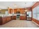 Traditional kitchen featuring wood cabinets, tile floors, stainless steel appliances, and granite countertops at 616 Smokehouse Ln, Albemarle, NC 28001