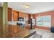 Kitchen featuring tile flooring, stainless steel appliances, and granite countertops with eat-in dining area at 616 Smokehouse Ln, Albemarle, NC 28001