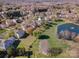 Overhead view of a neighborhood highlighting homes near a tranquil pond with fountain at 6720 Neuhoff Ln, Charlotte, NC 28269