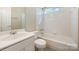 Cozy bathroom featuring tile surround shower-tub combo and integrated vanity at 6720 Neuhoff Ln, Charlotte, NC 28269