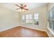 Bedroom with neutral walls, tiled floor, ceiling fan, and windows for ample natural light at 6720 Neuhoff Ln, Charlotte, NC 28269