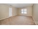 Neutral bedroom with carpet and a window at 6720 Neuhoff Ln, Charlotte, NC 28269