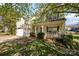 Welcoming home features a covered front porch, attached garage and beautifully landscaped yard at 6720 Neuhoff Ln, Charlotte, NC 28269