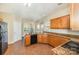 Bright kitchen featuring granite countertops, tile floors and wooden cabinetry at 6720 Neuhoff Ln, Charlotte, NC 28269