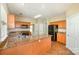 Large kitchen island with granite countertops, stainless steel sink, tile floors, and ample cabinet storage at 6720 Neuhoff Ln, Charlotte, NC 28269