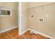 Utility room featuring tile flooring, storage shelves, and washer-dryer hookups at 6720 Neuhoff Ln, Charlotte, NC 28269