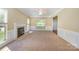 Bright living room featuring a fireplace, carpeted floors, and large windows at 6720 Neuhoff Ln, Charlotte, NC 28269