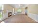 Bright living room featuring a fireplace, neutral carpet, ceiling fan, and ample natural light at 6720 Neuhoff Ln, Charlotte, NC 28269