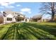 Rear exterior view of the home with a detached garage and manicured lawn at 810 Martingale Ln, Davidson, NC 28036