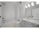 Bathroom featuring a bathtub, and a sink with a marble countertop at 810 Martingale Ln, Davidson, NC 28036