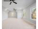 Bedroom with carpet, ceiling fans, and windows offering views of the surrounding landscape at 810 Martingale Ln, Davidson, NC 28036