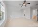 Large attic bedroom featuring a window and neutral carpet, with an ensuite bathroom at 810 Martingale Ln, Davidson, NC 28036