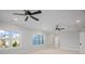 Bedroom with carpet, ceiling fans, and windows offering views of the surrounding landscape at 810 Martingale Ln, Davidson, NC 28036