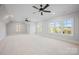 Bedroom with carpet, ceiling fans, and windows offering views of the surrounding landscape at 810 Martingale Ln, Davidson, NC 28036