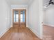 Entry foyer with wood floors and glass paneled double doors at 810 Martingale Ln, Davidson, NC 28036