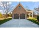 Exterior view of a two-car brick garage with a gable roof and a concrete driveway at 810 Martingale Ln, Davidson, NC 28036