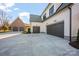 Three car garages with a concrete pad and brick trim at 810 Martingale Ln, Davidson, NC 28036