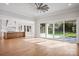 Spacious living room with hardwood floors, glass sliding doors and access to the kitchen at 810 Martingale Ln, Davidson, NC 28036