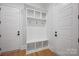 A well-organized mudroom with built-in storage, a bench, and hooks, perfect for keeping things tidy at 810 Martingale Ln, Davidson, NC 28036