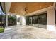 Large covered patio features travertine tile and glass sliding doors to the interior at 810 Martingale Ln, Davidson, NC 28036