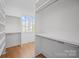 Walk-in closet featuring custom shelves and wood flooring at 810 Martingale Ln, Davidson, NC 28036