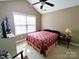 Spacious bedroom featuring a high ceiling with fan and neutral wall color and a large window at 810 Wynnshire Dr # D, Hickory, NC 28601