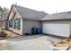 View of the home's exterior showing stone and siding details plus the two car garage at 810 Wynnshire Dr # D, Hickory, NC 28601