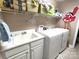 Bright laundry room with utility sink and appliances plus shelving for storage at 810 Wynnshire Dr # D, Hickory, NC 28601