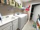 Functional laundry room with utility sink and appliances plus shelving storage at 810 Wynnshire Dr # D, Hickory, NC 28601