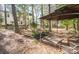 Backyard area showcasing a gazebo and a natural water feature, surrounded by lush greenery at 9131 Strattonville Ct, Huntersville, NC 28078