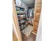 Walk-in closet featuring custom wood shelving, ample hanging space, and a decorative rug at 9131 Strattonville Ct, Huntersville, NC 28078