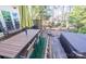 Outdoor wooden deck with dining set and grill, extending to a serene backyard space at 9131 Strattonville Ct, Huntersville, NC 28078