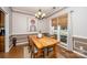 The dining room has a wood table, chairs, hardwood flooring, and natural light at 9131 Strattonville Ct, Huntersville, NC 28078