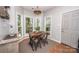 Charming breakfast nook bathed in natural light, complemented by rustic furniture and warm terracotta tile flooring at 9131 Strattonville Ct, Huntersville, NC 28078