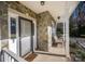 Inviting front porch with stone accents, seating, and a storm door, offering a warm welcome to visitors at 9131 Strattonville Ct, Huntersville, NC 28078