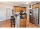 Well-lit kitchen with stainless steel appliances, custom wood cabinets, and terra cotta tile flooring at 9131 Strattonville Ct, Huntersville, NC 28078