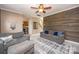 Comfortable living room with wood accent wall, tile flooring, and plush gray seating at 9131 Strattonville Ct, Huntersville, NC 28078