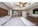 A cozy main bedroom featuring an upholstered bed, natural light and tray ceiling with ceiling fan at 9131 Strattonville Ct, Huntersville, NC 28078