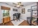 Office space featuring hardwood floors, a window, wooden blinds, and an office desk setup at 9131 Strattonville Ct, Huntersville, NC 28078