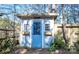 Charming shed with a blue door and flower boxes, nestled among trees and plants at 9131 Strattonville Ct, Huntersville, NC 28078