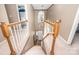 View from the top of a staircase with oak banisters in a neutral, two story home at 9131 Strattonville Ct, Huntersville, NC 28078